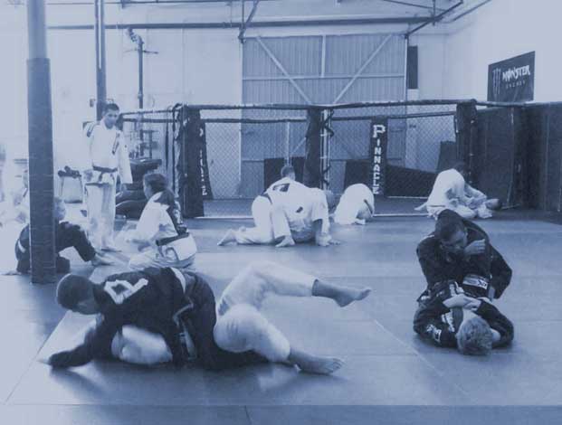 kids practicing jiu-jitsu by sparring during class